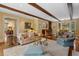 Open-concept living room features beamed ceilings, hardwood floors, and access to dining room at 905 Stovall Ne Blvd, Atlanta, GA 30319