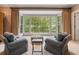 Relaxing sitting area in the bedroom with armchairs and large windows overlooking backyard at 905 Stovall Ne Blvd, Atlanta, GA 30319