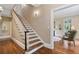 Elegant staircase with wood treads and white risers leading to a living area with hardwood floors at 905 Stovall Ne Blvd, Atlanta, GA 30319
