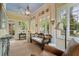 Bright sunroom with many windows, wood floors, stylish furniture and decor, and lots of natural light at 905 Stovall Ne Blvd, Atlanta, GA 30319