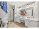 Well-lit bathroom with dual vanity, tile floors, and large mirror, offering ample space for personal care at 1364 Keys Crossing Ne Dr, Atlanta, GA 30319