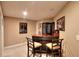 Basement bar area with seating, dark wooden bar and framed prints on the walls at 1850 Noblin Ridge Way, Duluth, GA 30097