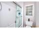White tiled shower and bath next to a toilet, framed window and silver hardware at 1850 Noblin Ridge Way, Duluth, GA 30097