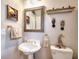 Charming powder room with vintage style fixtures and whimsical decorative accents at 1850 Noblin Ridge Way, Duluth, GA 30097