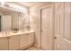 Neutral bathroom with double sink vanity and large framed mirror above at 1850 Noblin Ridge Way, Duluth, GA 30097