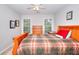 Bedroom with a wooden bed frame, two windows with natural light and neutral decor at 1850 Noblin Ridge Way, Duluth, GA 30097