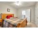 Cozy bedroom featuring a wooden bed frame and warm, inviting decor at 1850 Noblin Ridge Way, Duluth, GA 30097