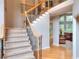 Welcoming foyer with staircase and hardwood floors, and an open view to the living spaces at 1850 Noblin Ridge Way, Duluth, GA 30097