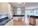 Well-lit kitchen with stainless steel appliances, hardwood floors, granite countertops and breakfast bar area at 1850 Noblin Ridge Way, Duluth, GA 30097