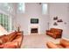 Spacious living room featuring large windows, a fireplace, and comfortable seating at 1850 Noblin Ridge Way, Duluth, GA 30097