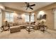 Spacious living room with plush seating, ceiling fan, and large windows with natural light at 1850 Noblin Ridge Way, Duluth, GA 30097