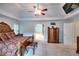 Spacious main bedroom with elegant furnishings, a ceiling fan, and access to an ensuite bathroom at 1850 Noblin Ridge Way, Duluth, GA 30097