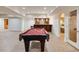Spacious basement featuring a pool table, bar area, and doorway leading to exercise room at 314 Caruso Ct, Sandy Springs, GA 30350