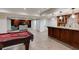 Finished basement boasts a pool table, wet bar, and separate living area with built-in shelving at 314 Caruso Ct, Sandy Springs, GA 30350