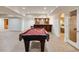 Spacious basement features a pool table, wet bar, and access to a fitness area; perfect for entertaining guests at 314 Caruso Ct, Sandy Springs, GA 30350