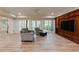 Basement living room with a TV, built-in shelving, a ceiling fan, and a gray sofa at 314 Caruso Ct, Sandy Springs, GA 30350