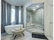 Bathroom featuring a soaking tub, large shower, elegant curtained windows, and stylish light fixture at 314 Caruso Ct, Sandy Springs, GA 30350