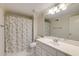 Clean, all-white bathroom featuring a shower-tub combination, a large mirror, and ample cabinet space at 314 Caruso Ct, Sandy Springs, GA 30350