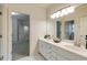 Double sink bathroom with a modern vanity and a mirror reflecting another bathroom at 314 Caruso Ct, Sandy Springs, GA 30350