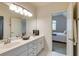 Double sink bathroom with modern vanity and a glimpse into an adjoining bedroom at 314 Caruso Ct, Sandy Springs, GA 30350