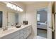 Bathroom featuring double sinks, tiled floor, and view to bedroom with ensuite bath at 314 Caruso Ct, Sandy Springs, GA 30350