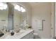 Bright bathroom featuring a large mirror, ample lighting, and a pristine white vanity at 314 Caruso Ct, Sandy Springs, GA 30350