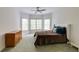 Bedroom with green carpet, a bed with a decorative brown comforter, and a nearby chest of drawers at 314 Caruso Ct, Sandy Springs, GA 30350