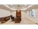 Basement office area with built in bookcase and storage, a ceiling fan and natural light at 314 Caruso Ct, Sandy Springs, GA 30350