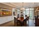 Cozy dining area with a wooden table set under an elegant chandelier and large windows at 314 Caruso Ct, Sandy Springs, GA 30350