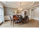 Dining room with chandelier, trim detail, and hardwood floors at 314 Caruso Ct, Sandy Springs, GA 30350