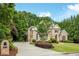 Beautiful two-story brick home with well-kept landscaping and an inviting driveway, surrounded by mature trees at 314 Caruso Ct, Sandy Springs, GA 30350
