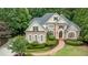 Charming brick home featuring manicured landscaping, a brick walkway, and an elegant facade at 314 Caruso Ct, Sandy Springs, GA 30350