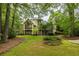 Spacious backyard featuring a well-manicured lawn and brick home with balconies at 314 Caruso Ct, Sandy Springs, GA 30350