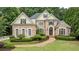 Beautiful brick home with meticulously landscaped front yard and inviting curb appeal at 314 Caruso Ct, Sandy Springs, GA 30350