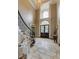 Impressive foyer with soaring ceilings, stone tile floor, graceful staircase, and a grand arched window at 314 Caruso Ct, Sandy Springs, GA 30350