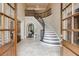 Grand foyer with a curved staircase, travertine floors, and abundant natural light at 314 Caruso Ct, Sandy Springs, GA 30350