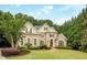 Charming brick home with well-kept lawn, manicured bushes, and a symmetrical design, perfect for families at 314 Caruso Ct, Sandy Springs, GA 30350