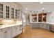 Bright, white kitchen with stainless steel appliances, custom cabinets, and hardwood floors offers a modern touch at 314 Caruso Ct, Sandy Springs, GA 30350