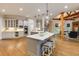 The open kitchen features seating at the island, stainless appliances, and is open to the living room at 314 Caruso Ct, Sandy Springs, GA 30350