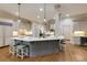 Modern kitchen island with pendant lighting and barstool seating, perfect for casual dining and entertaining guests at 314 Caruso Ct, Sandy Springs, GA 30350