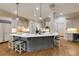 Stunning open kitchen showcases an expansive center island with bar seating, stainless appliances, and custom cabinetry at 314 Caruso Ct, Sandy Springs, GA 30350