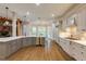 Bright kitchen features gray cabinetry, stainless appliances, lots of natural light, and beautiful hardwood floors at 314 Caruso Ct, Sandy Springs, GA 30350