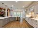 Gourmet kitchen with stainless steel appliances, custom cabinets, granite countertops, and hardwood floors at 314 Caruso Ct, Sandy Springs, GA 30350