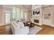 Living room with fireplace and tall windows overlooking the backyard at 314 Caruso Ct, Sandy Springs, GA 30350
