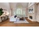 Bright living room with high ceilings, fireplace, large windows, and hardwood flooring at 314 Caruso Ct, Sandy Springs, GA 30350