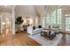 Bright living room featuring a fireplace, high ceilings, and large windows with natural light at 314 Caruso Ct, Sandy Springs, GA 30350