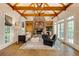 Inviting living room featuring a stone fireplace, wood beams, and French doors at 314 Caruso Ct, Sandy Springs, GA 30350
