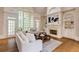 Inviting living room featuring a fireplace, built-in shelves, and doors that open to the outdoors at 314 Caruso Ct, Sandy Springs, GA 30350