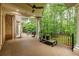 Covered back deck overlooks manicured lawn and beautiful wooded area offering a great view at 314 Caruso Ct, Sandy Springs, GA 30350