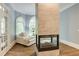 Main bedroom fireplace and sitting area adjacent to french doors with view to backyard at 314 Caruso Ct, Sandy Springs, GA 30350